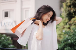 Happy Woman With Shopping Bags on shoulder