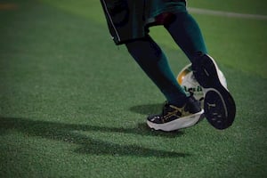 A kid dribbling the ball