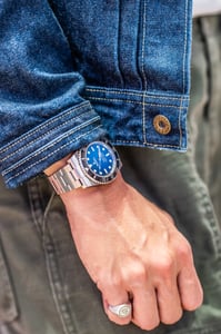 A man with his Rolex Submariner luxury watch