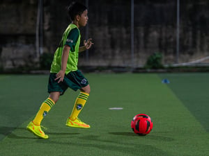 Boy dribbling the ball