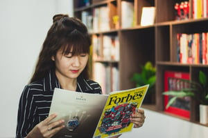 A lady reading Forbes