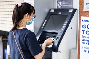 A girl using an ATM machine