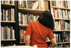 Girl selecting books in the bookstore