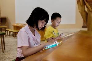 Sister and brother are using tablet