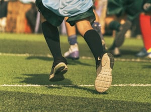Kid running in a football field