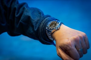 Man looking at his hard-earned Rolex Luxury Watch
