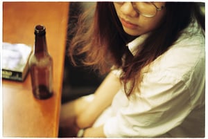 Thoughtful girl with a beer bottle