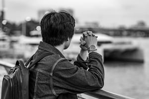 Man looking afar with his Rolex watch